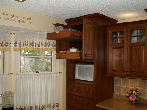 Pull out shelves in this tall custom cabinet with big drawers