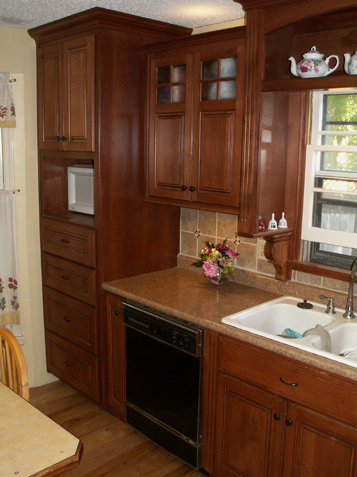 Staggered height uppers with corbels and open display Custom Kitchen by KC Wood Lenexa Kansas