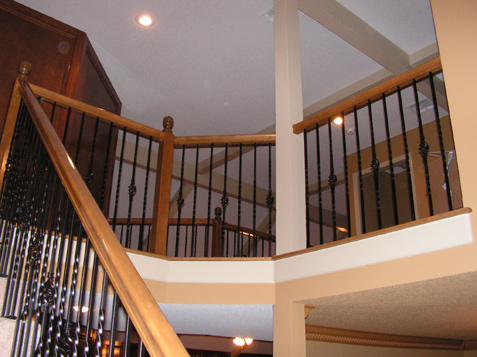 separating the 'basket' spindles with simple 'twist' spindles - not only keeps the staircase from getting to busy but also saves money because the twist spindles cost less